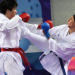 Iran's Hamideh Abbasali (R) fights against China's Zeng Cuilan (L) in the karate kumite women's 68kg finals in Gyeyang gymnasium in Incheon on October 2, 2014. AFP PHOTO / ROSLAN RAHMAN (Photo by ROSLAN RAHMAN / AFP)